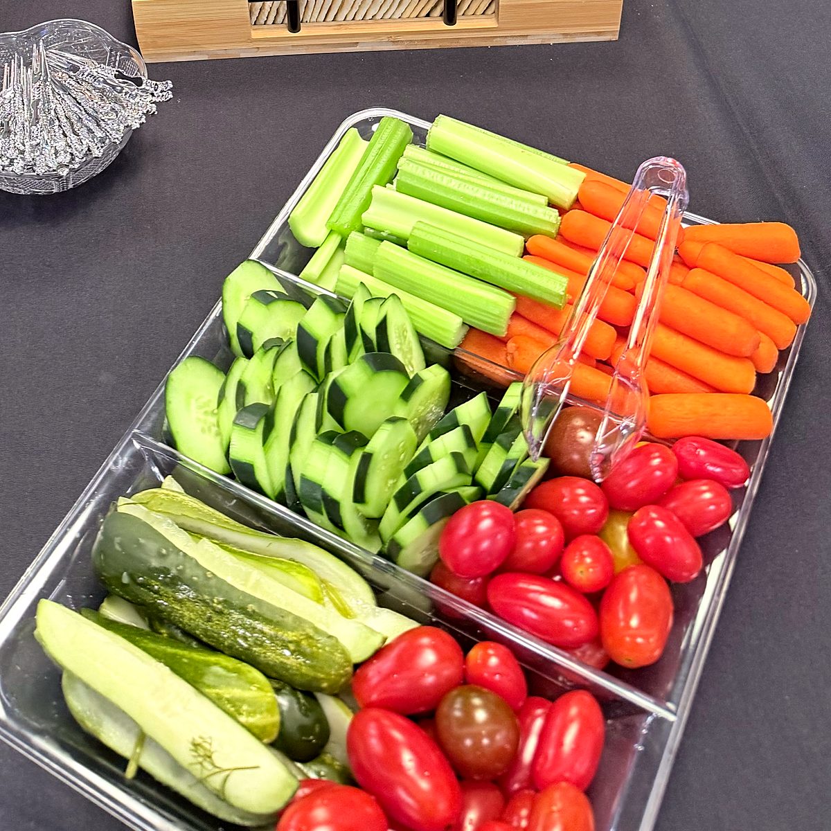 Close-up of a fresh vegetable platter with celery sticks, baby carrots, cucumber slices and cherry tomatoes